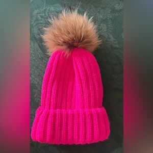 Vibrant pink hat with pompom ball
